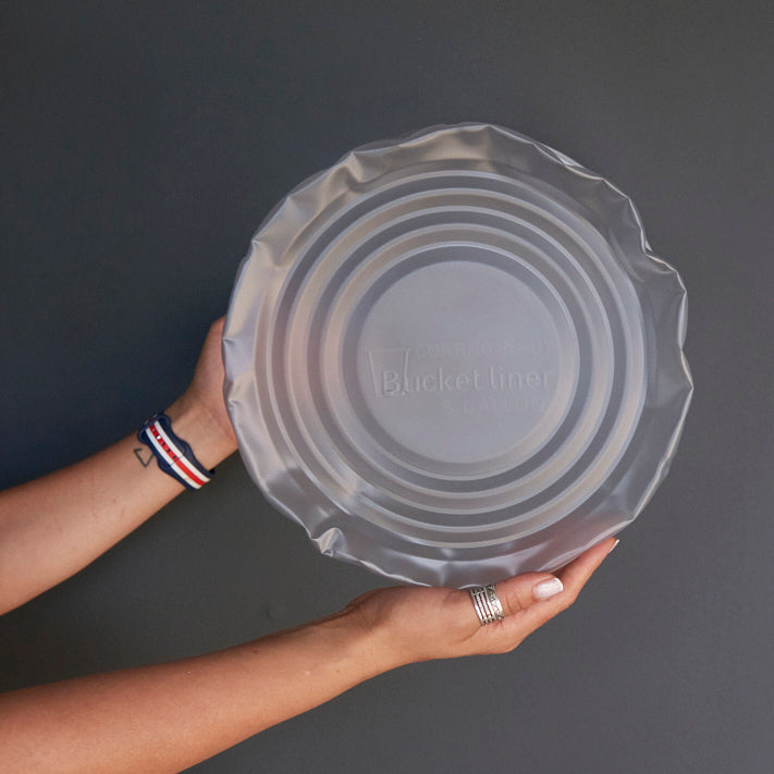 Custom labeled plastic liner hand holding from bottom up 